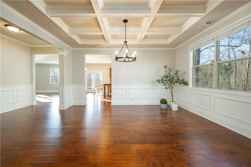 5875 Chestnut Drive Cumming, GA 30040 - Photo 13 of 55 a view of an empty room with wooden floor and a window