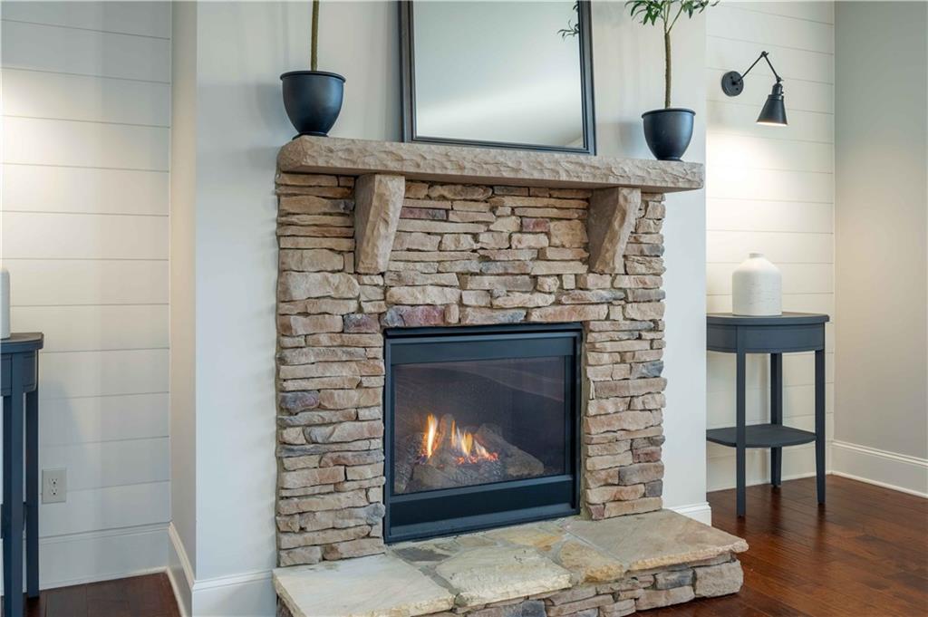 5875 Chestnut Drive Cumming, GA 30040 - Photo 17 of 55 a fireplace with a clock on top of it