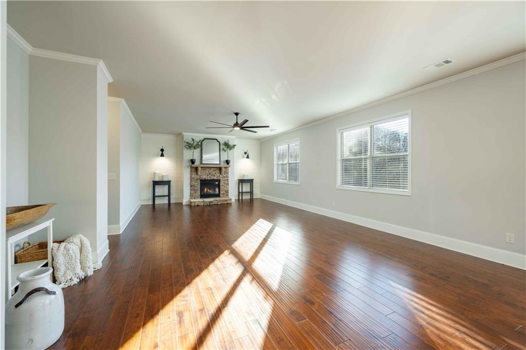 5875 Chestnut Drive Cumming, GA 30040 - Photo 18 of 55 a view of a living room and dining room with wooden floor