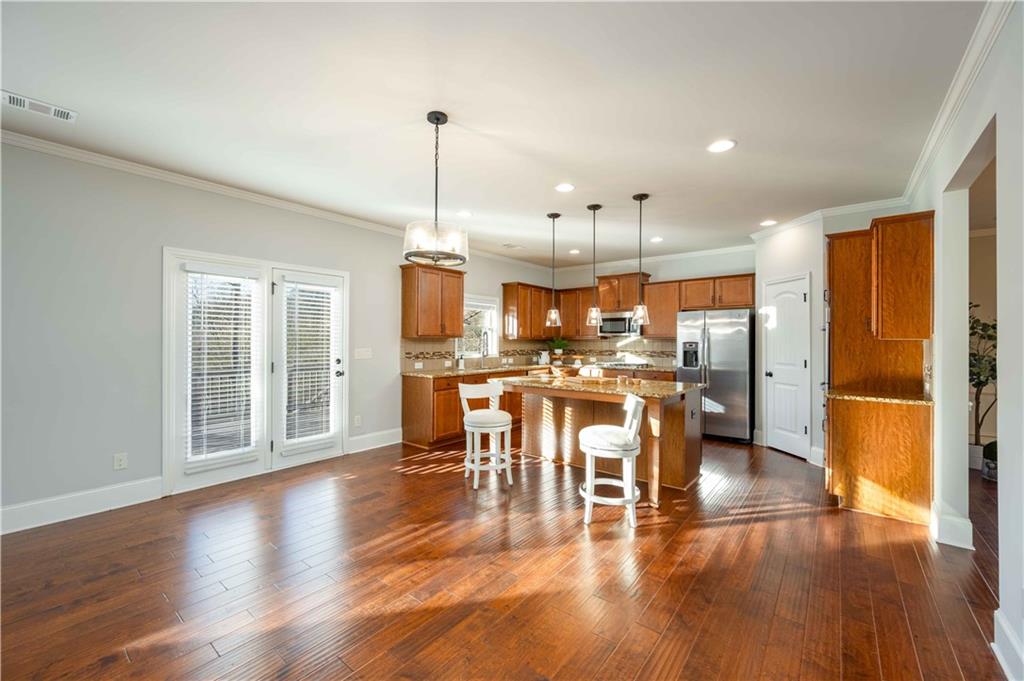 5875 Chestnut Drive Cumming, GA 30040 - Photo 20 of 55 a view of a kitchen with dining room wooden floor electric appliances and windows
