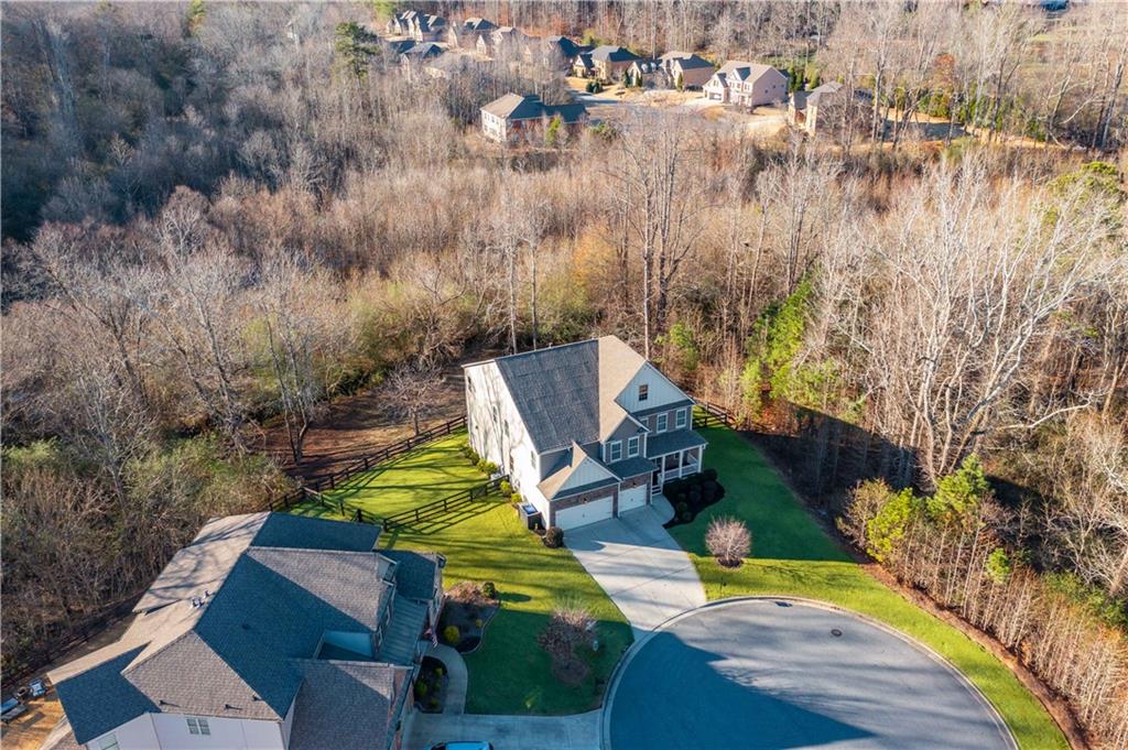 5875 Chestnut Drive Cumming, GA 30040 - Photo 2 of 55 an aerial view of a house with a yard and lake view