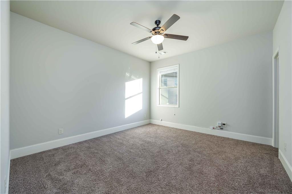 5875 Chestnut Drive Cumming, GA 30040 - Photo 27 of 55 an empty room with windows and fan