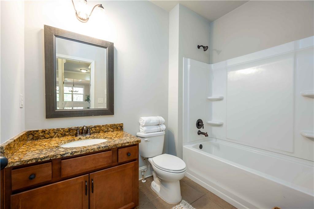 5875 Chestnut Drive Cumming, GA 30040 - Photo 28 of 55 a bathroom with a granite countertop sink toilet and shower