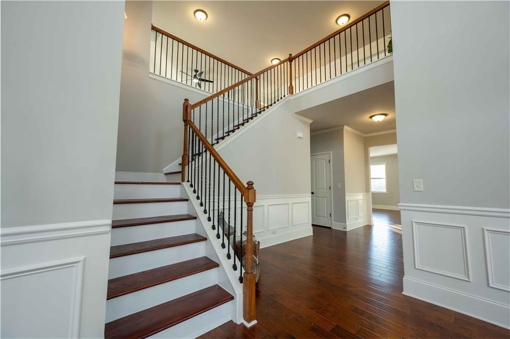 5875 Chestnut Drive Cumming, GA 30040 - Photo 29 of 55 a view of staircase with wooden floor and white walls