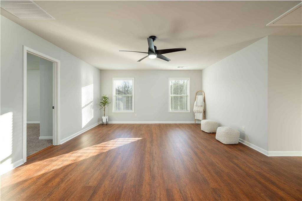 5875 Chestnut Drive Cumming, GA 30040 - Photo 31 of 55 a view of an empty room with wooden floor and a window