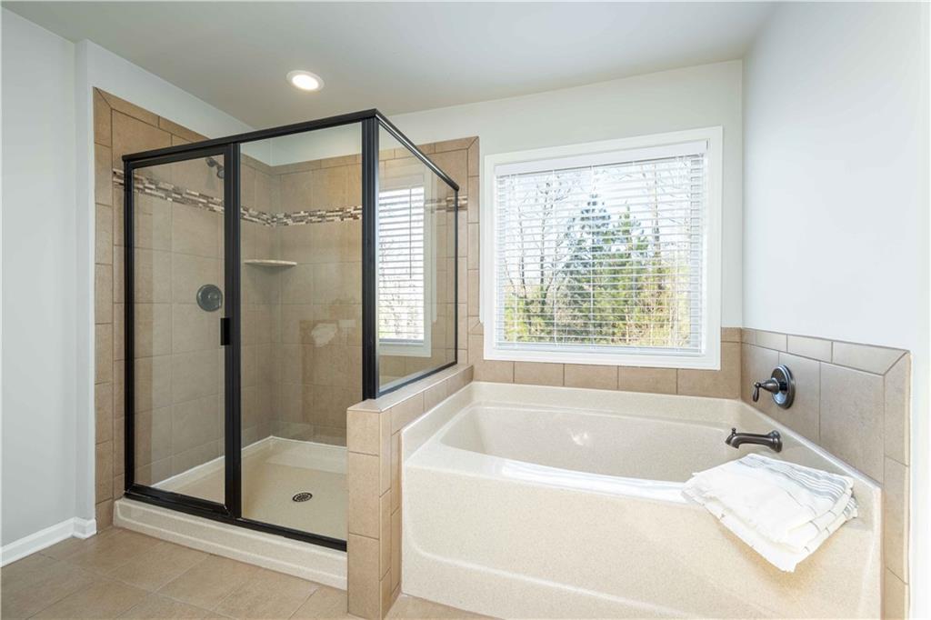 5875 Chestnut Drive Cumming, GA 30040 - Photo 36 of 55 a bathroom with a tub shower and sink