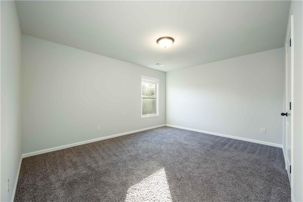 5875 Chestnut Drive Cumming, GA 30040 - Photo 40 of 55 an empty room with windows