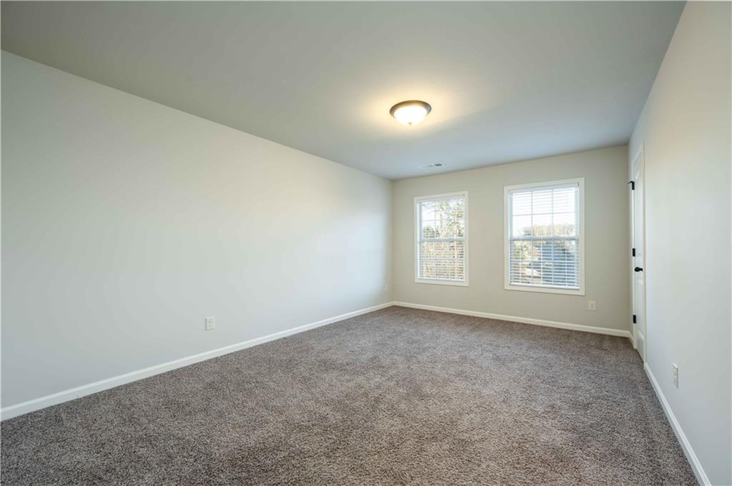 5875 Chestnut Drive Cumming, GA 30040 - Photo 42 of 55 an empty room with windows