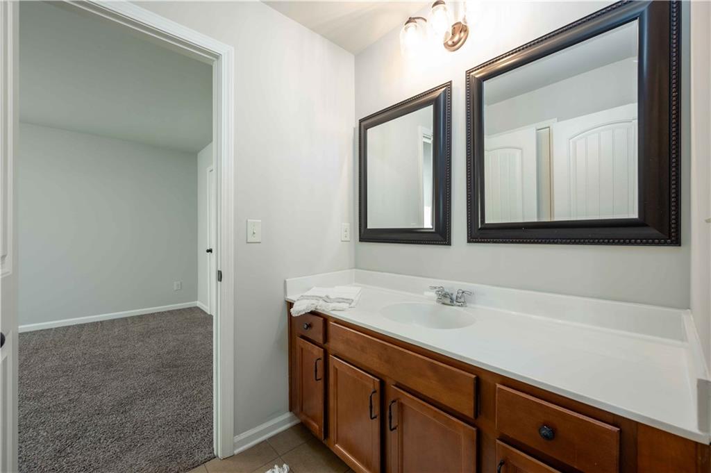 5875 Chestnut Drive Cumming, GA 30040 - Photo 43 of 55 a bathroom with a sink and a mirror