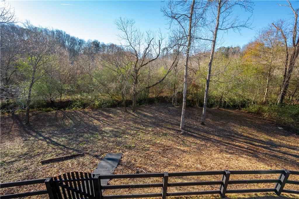 5875 Chestnut Drive Cumming, GA 30040 - Photo 48 of 55 a backyard of a house with lots of green space