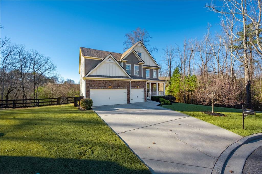 5875 Chestnut Drive Cumming, GA 30040 - Photo 5 of 55 a front view of a house with a yard and garage