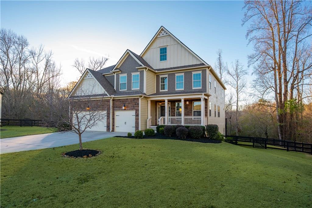 5875 Chestnut Drive Cumming, GA 30040 - Photo 6 of 55 a front view of a house with a yard and trees