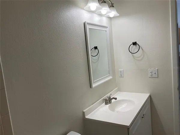 a bathroom with a sink vanity and a mirror