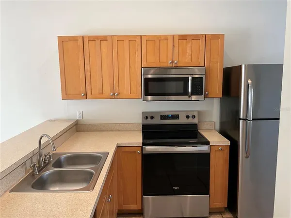 a kitchen with a sink stove and microwave