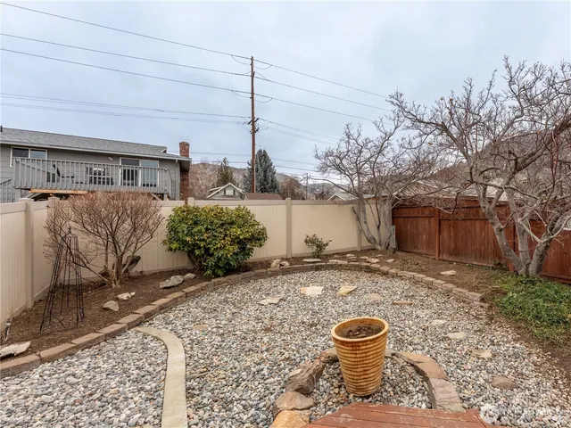 a view of a backyard with sitting area