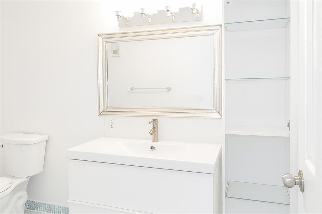 4200 Hillcrest Drive, Unit 201 Hollywood, FL 33021 - Photo 12 of 24 a bathroom with a sink and a mirror
