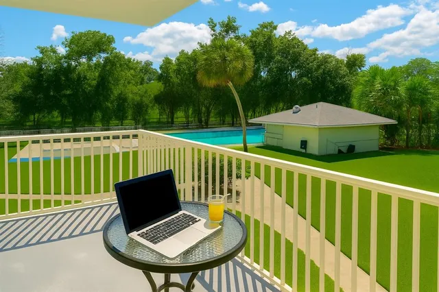 a view of deck with furniture and a yard