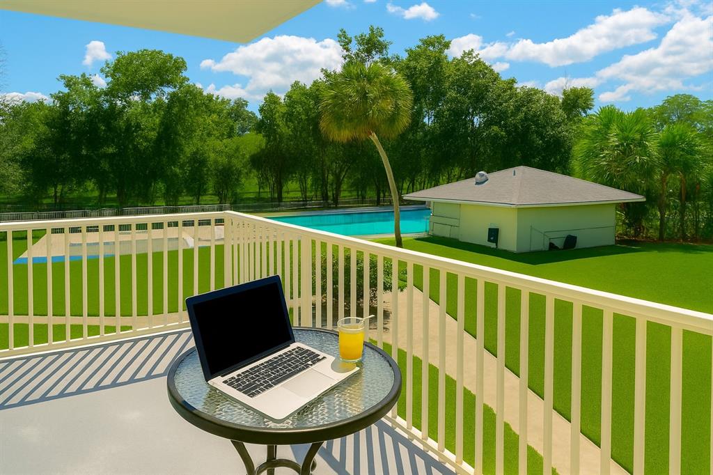 4200 Hillcrest Drive, Unit 201 Hollywood, FL 33021 - Photo 2 of 24 a view of deck with furniture and a yard