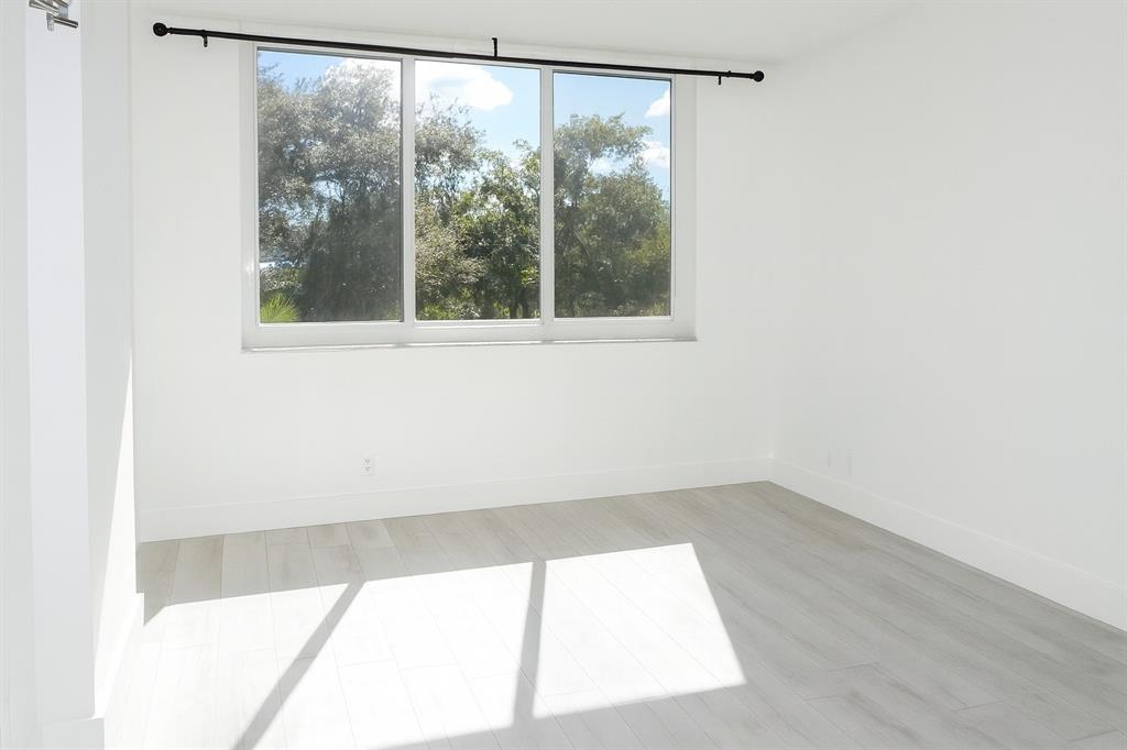 4200 Hillcrest Drive, Unit 201 Hollywood, FL 33021 - Photo 8 of 24 a view of a big room with wooden floor and windows