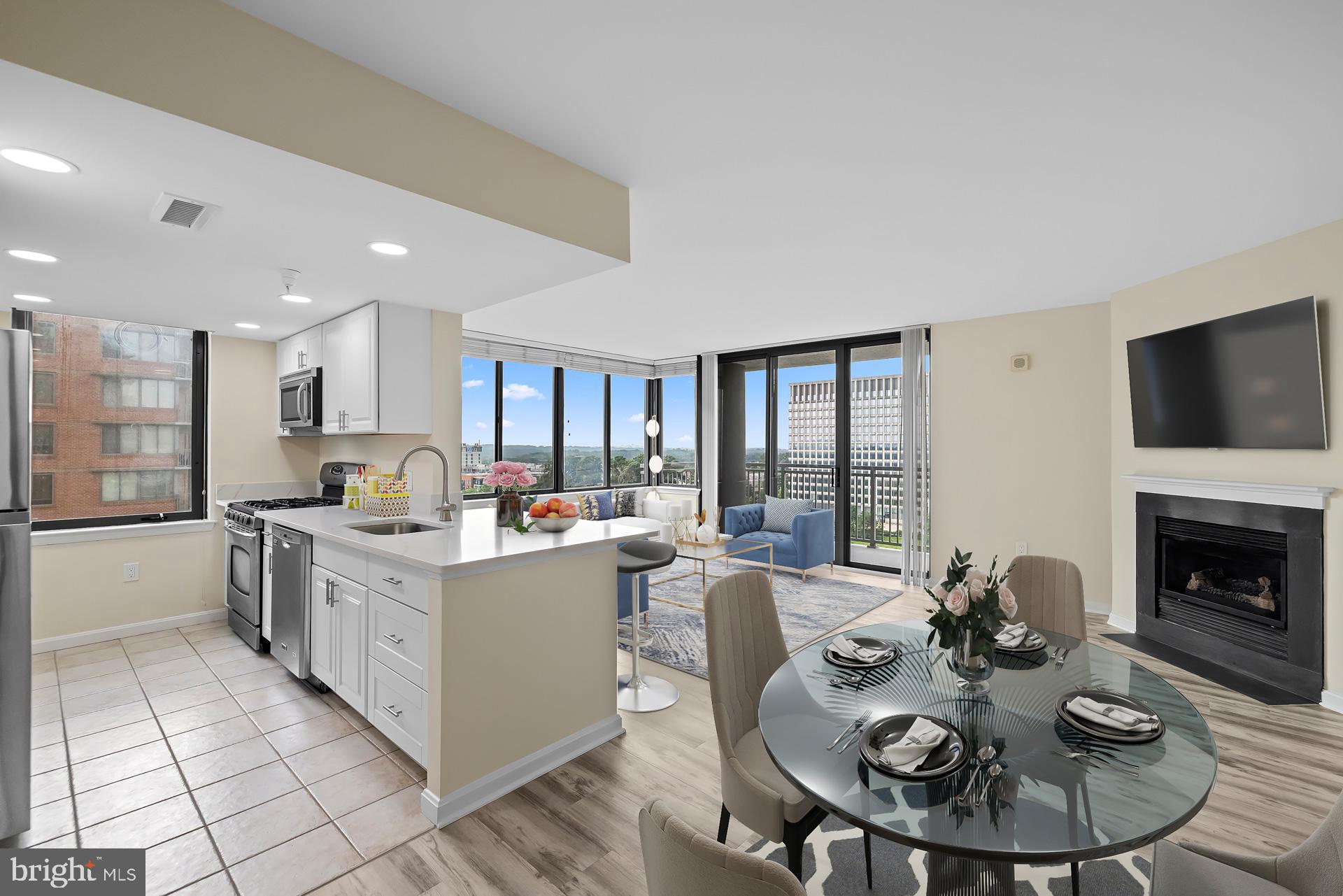 a open dining room with furniture a fireplace and kitchen view