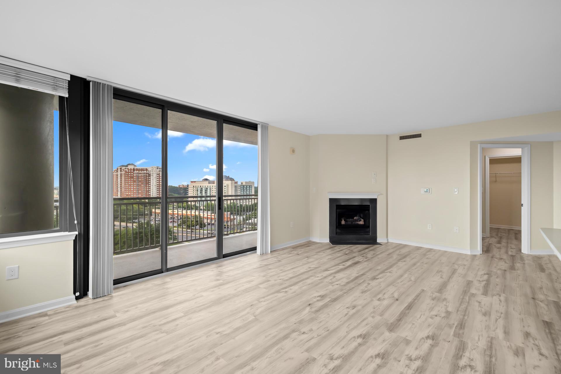 11710 Old Georgetown Road, Unit 1116W North Bethesda, MD 20852 - Photo 12 of 52 a view of an empty room with wooden floor and a window