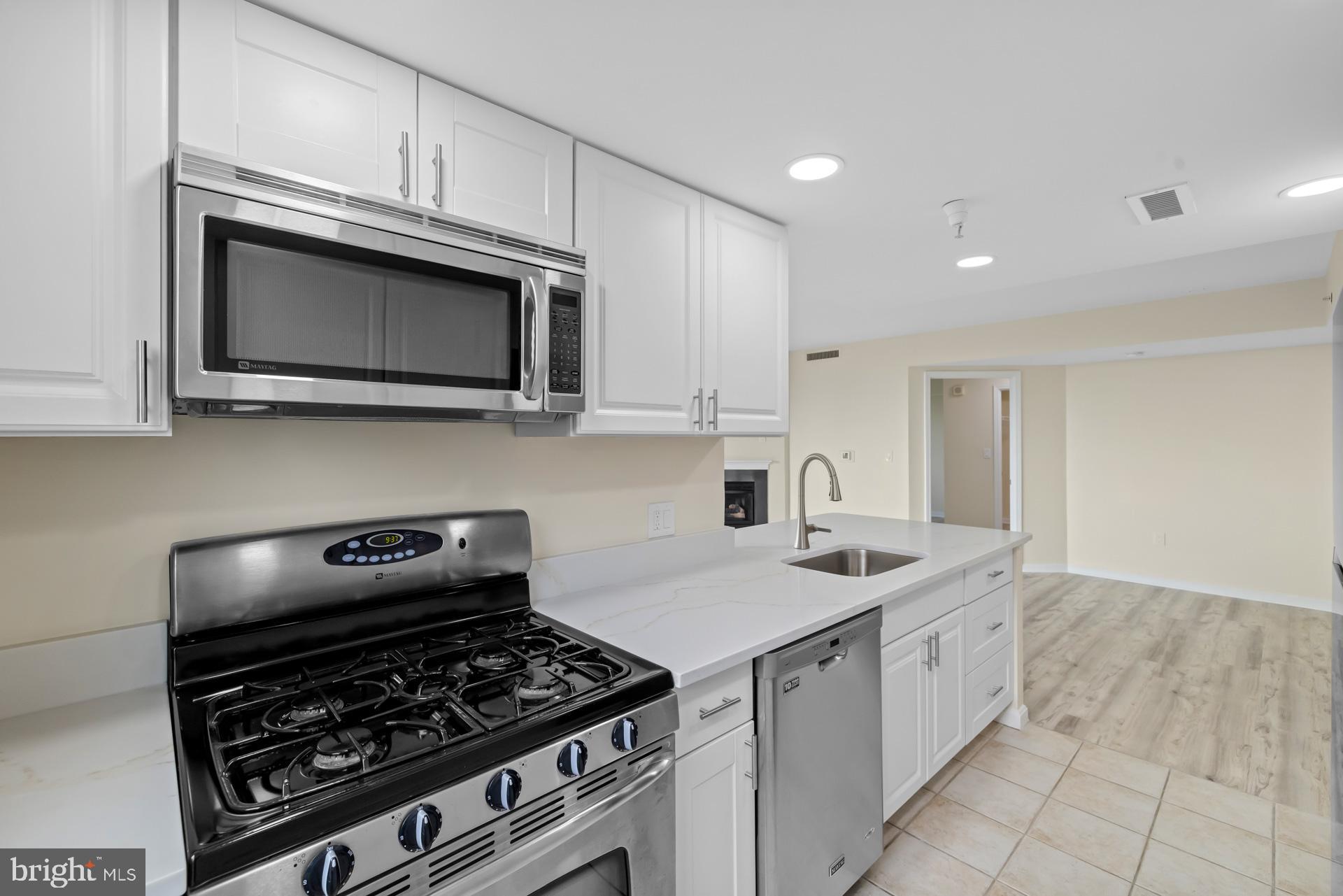 11710 Old Georgetown Road, Unit 1116W North Bethesda, MD 20852 - Photo 14 of 52 a kitchen with granite countertop a stove and a sink