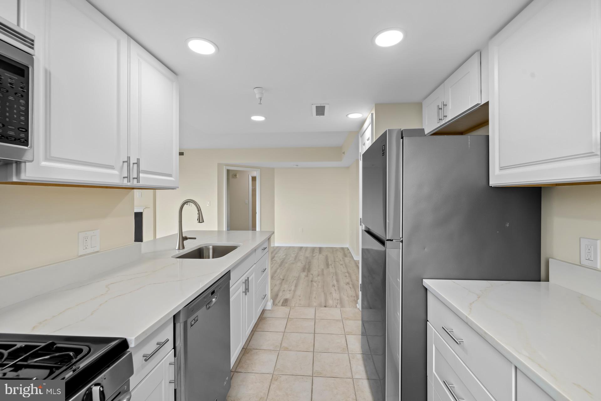 11710 Old Georgetown Road, Unit 1116W North Bethesda, MD 20852 - Photo 15 of 52 a kitchen with stainless steel appliances granite countertop a refrigerator and a sink