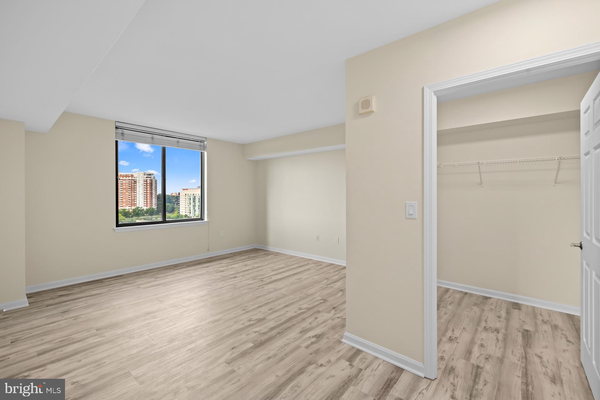 11710 Old Georgetown Road, Unit 1116W North Bethesda, MD 20852 - Photo 20 of 52 a view of an empty room with window and wooden floor