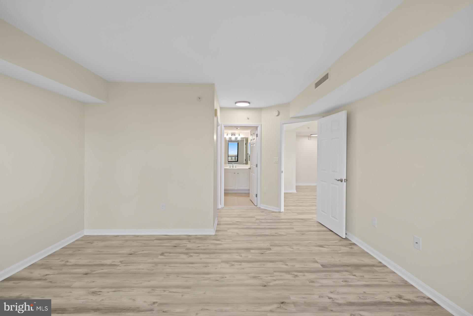 11710 Old Georgetown Road, Unit 1116W North Bethesda, MD 20852 - Photo 21 of 52 a view of an empty room with wooden floor