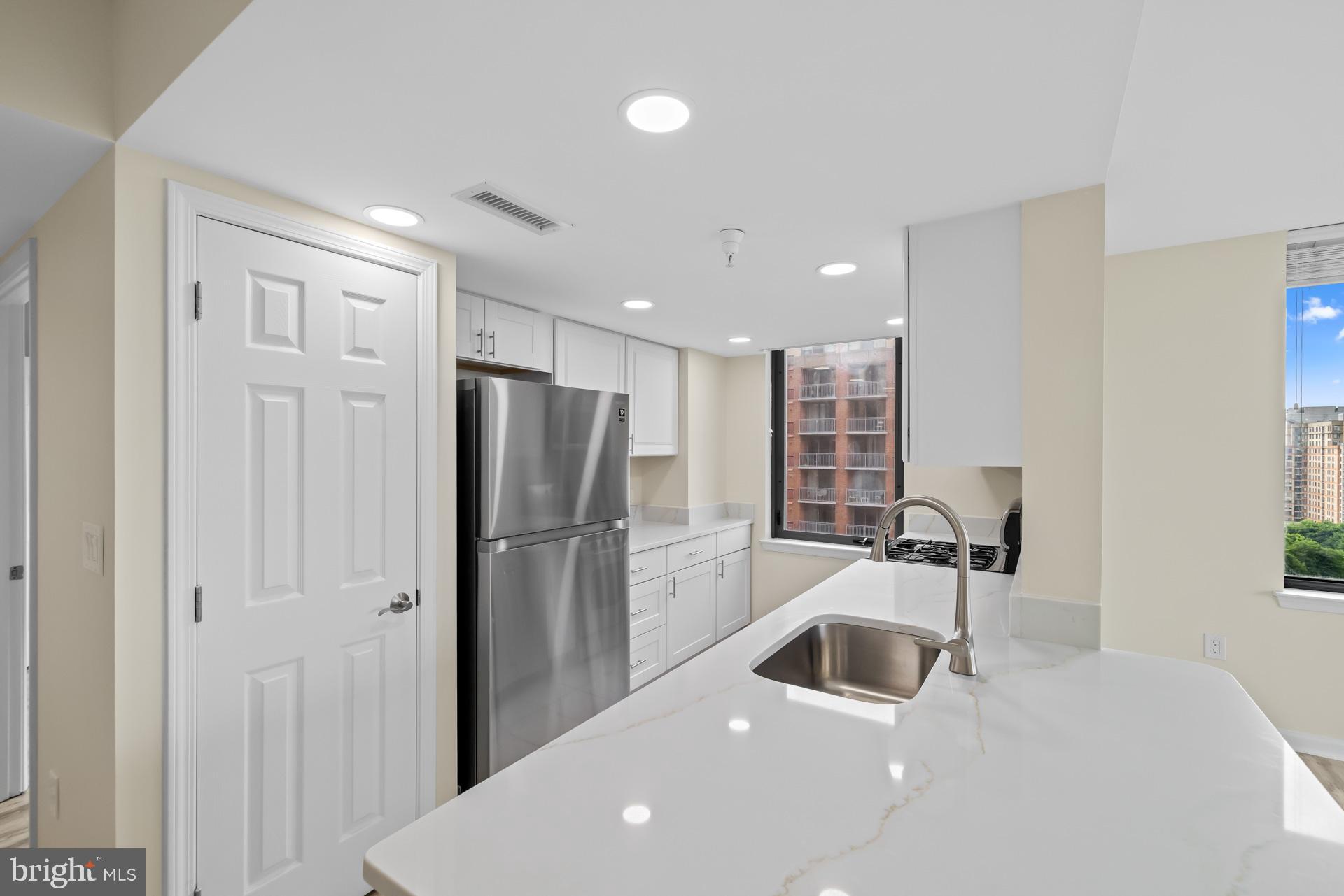11710 Old Georgetown Road, Unit 1116W North Bethesda, MD 20852 - Photo 4 of 52 a kitchen with a refrigerator a sink and a stove