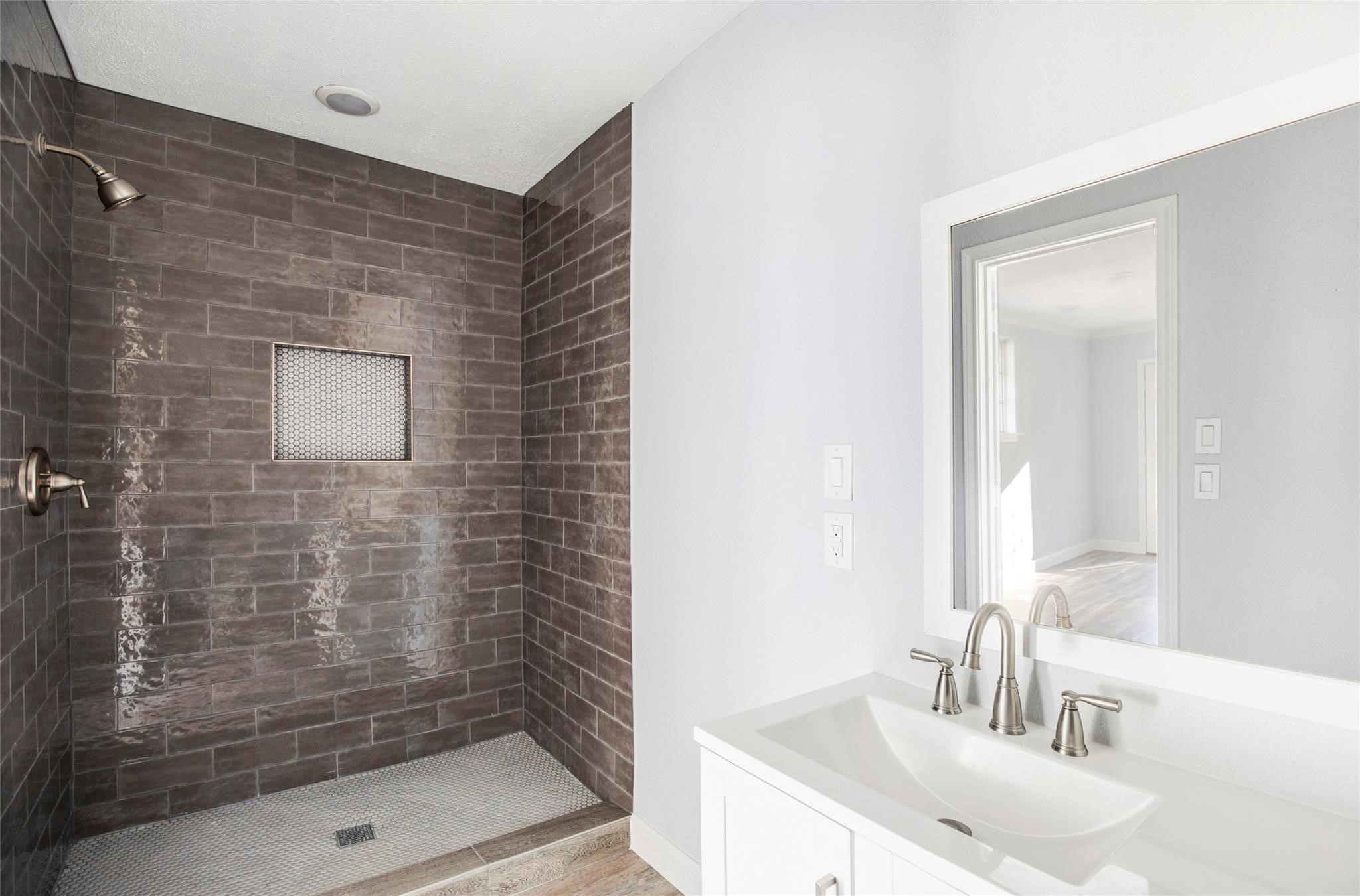 1 Mill Creek Road Point Blank, TX 77364 - Photo 29 of 43 a bathroom with a shower a sink and a mirror