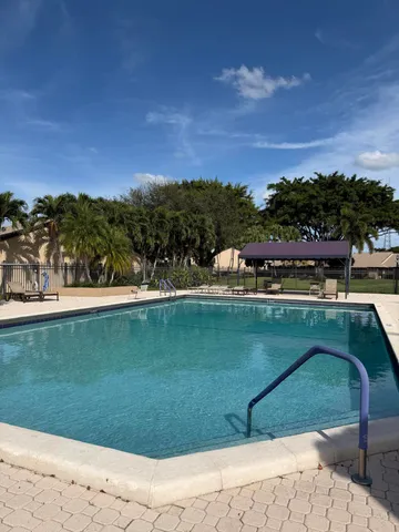 a view of a swimming pool with a yard