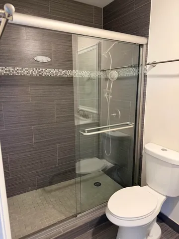 a bathroom with a toilet and a shower