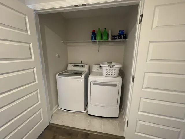 a utility room with closet dryer and washer