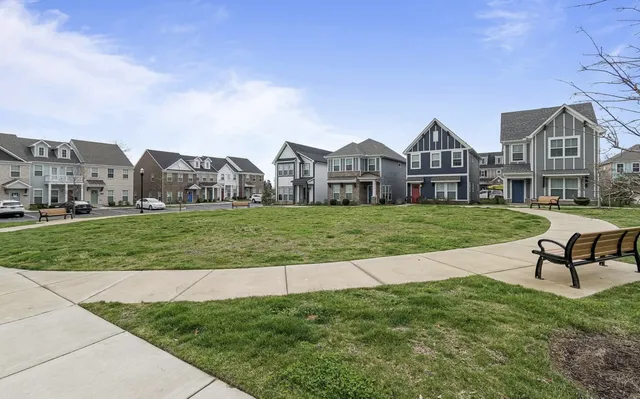 a view of a house with a yard and sitting area