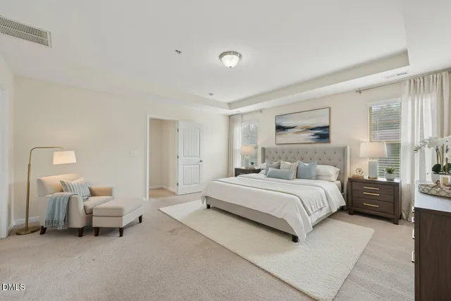 a spacious bedroom with a bed and a couch