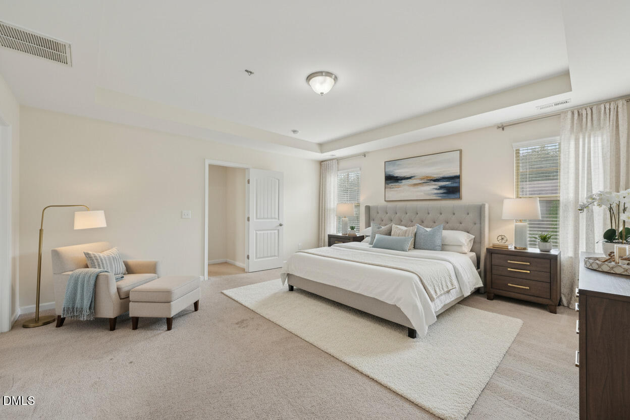 1024 Laredo Lane Durham, NC 27703 - Photo 15 of 32 a spacious bedroom with a bed and a couch