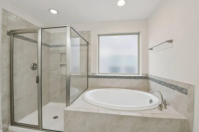 a bathroom with a white bath tub and a shower