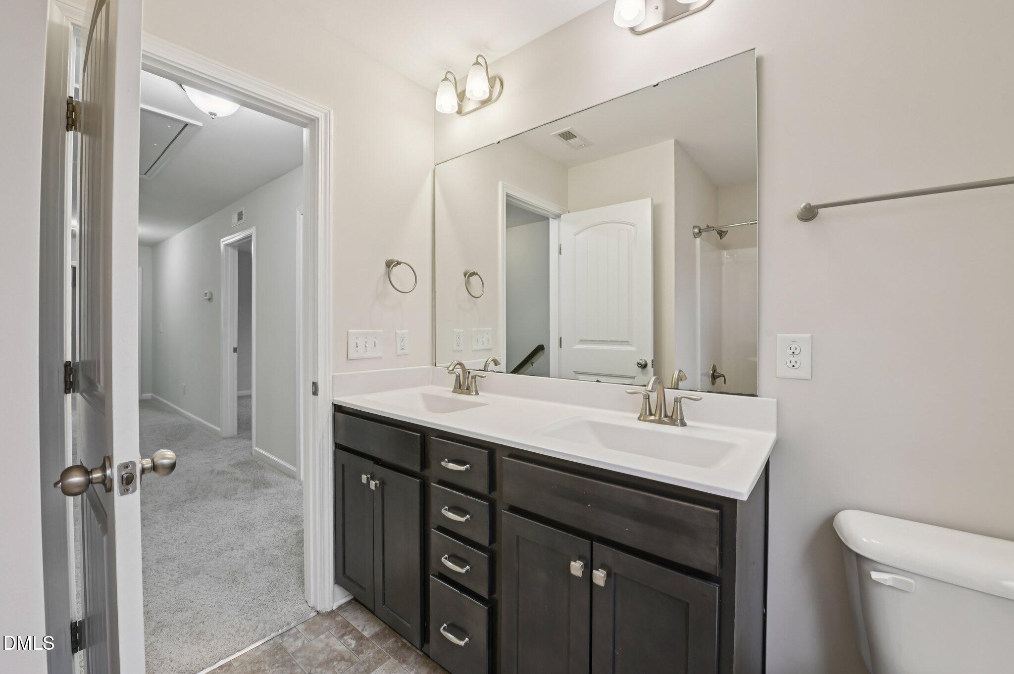 1024 Laredo Lane Durham, NC 27703 - Photo 26 of 32 a bathroom with a double vanity sink mirror and toilet