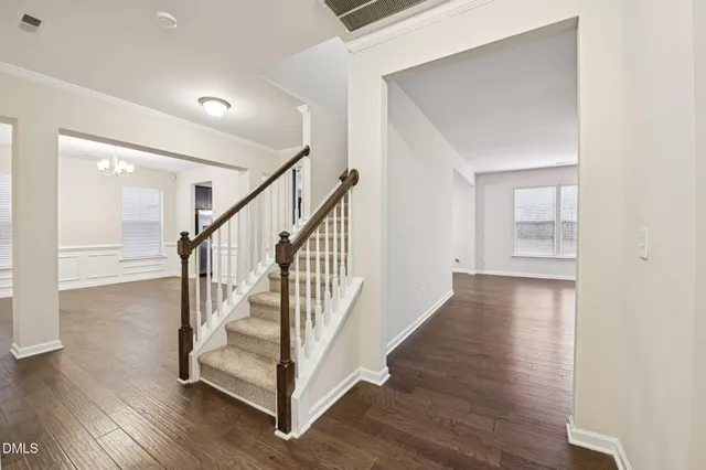 a view of a hallway with wooden floor and entryway