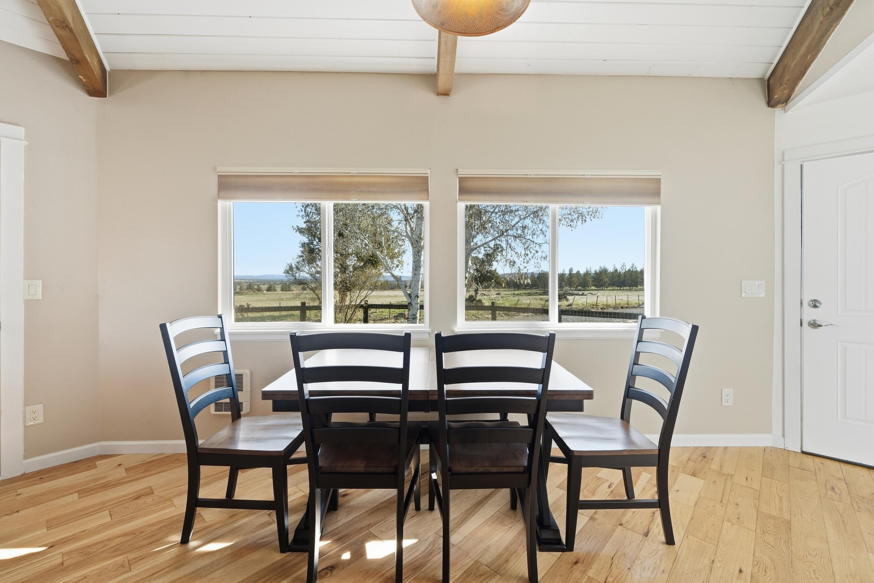 4074 Southwest Reif Road Powell Butte, OR 97753 - Photo 9 of 59 a view of a dining room with furniture window and outside view