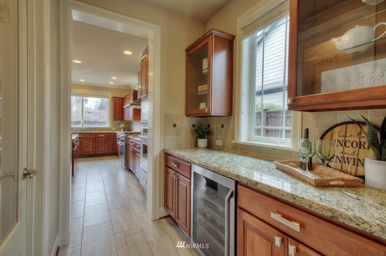 123 Ilwaco Place Southeast Renton, WA 98059 - Photo 11 of 33 a kitchen with granite countertop a sink a counter space and cabinets