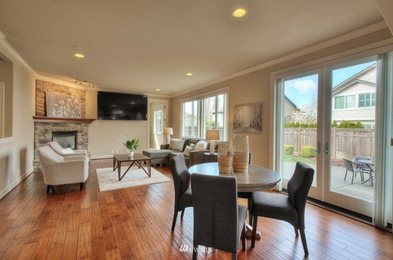 123 Ilwaco Place Southeast Renton, WA 98059 - Photo 12 of 33 a living room with fireplace furniture and a flat screen tv