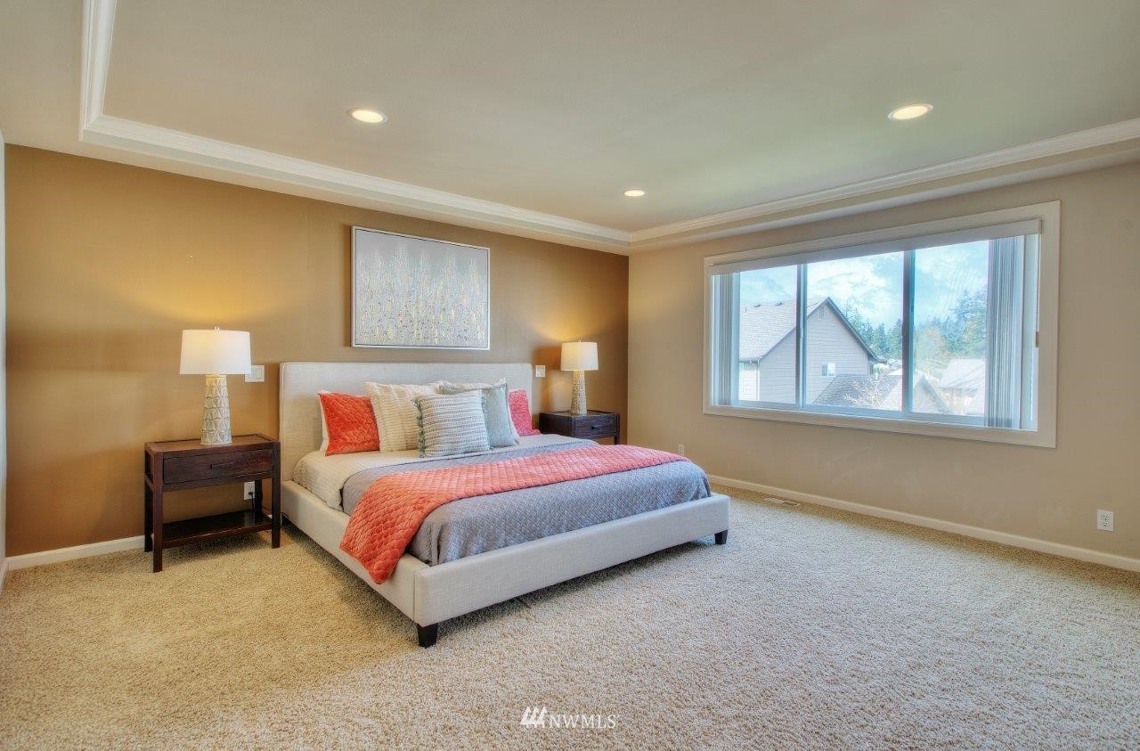 123 Ilwaco Place Southeast Renton, WA 98059 - Photo 20 of 33 a spacious bedroom with a bed and window