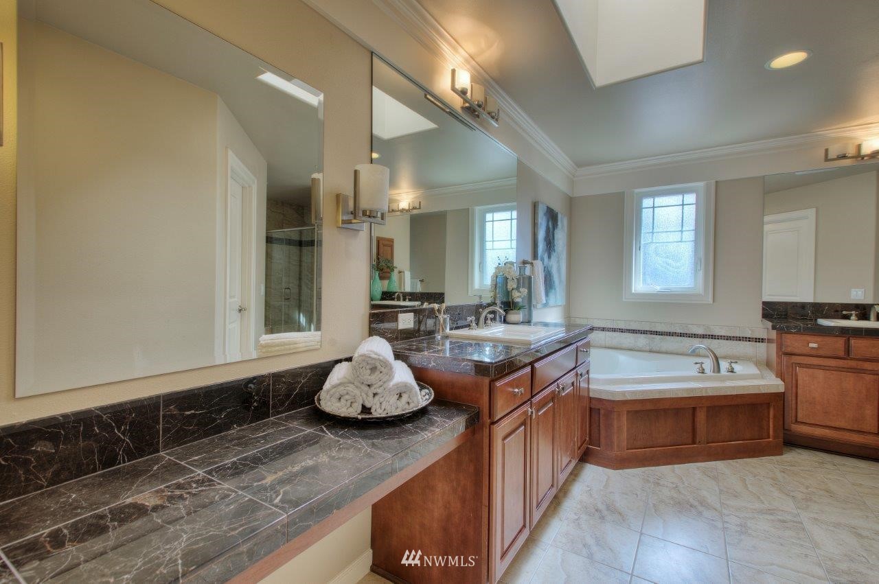 123 Ilwaco Place Southeast Renton, WA 98059 - Photo 23 of 33 a spacious bathroom with a tub sink and mirror