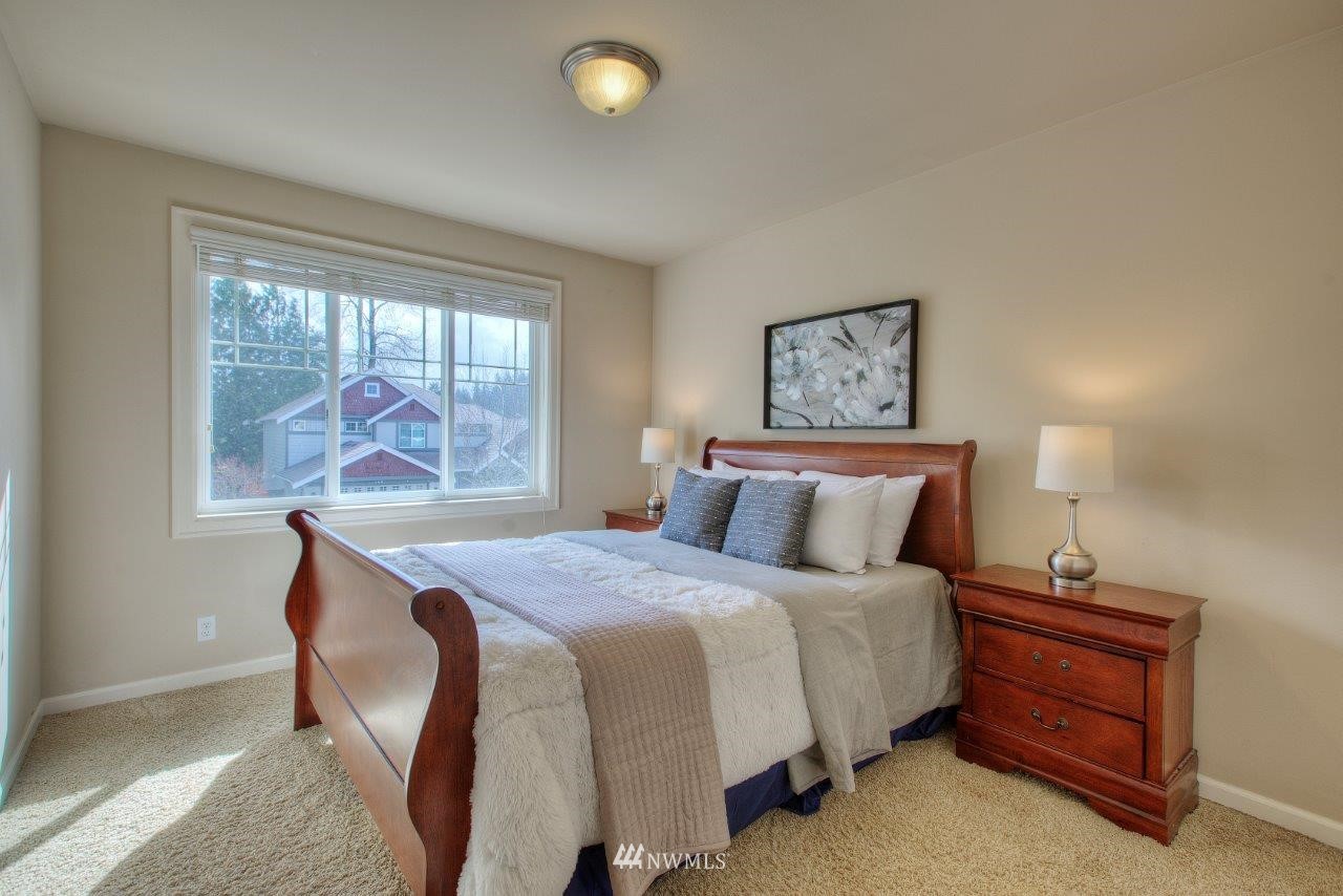 123 Ilwaco Place Southeast Renton, WA 98059 - Photo 28 of 33 a bedroom with a bed and a large window