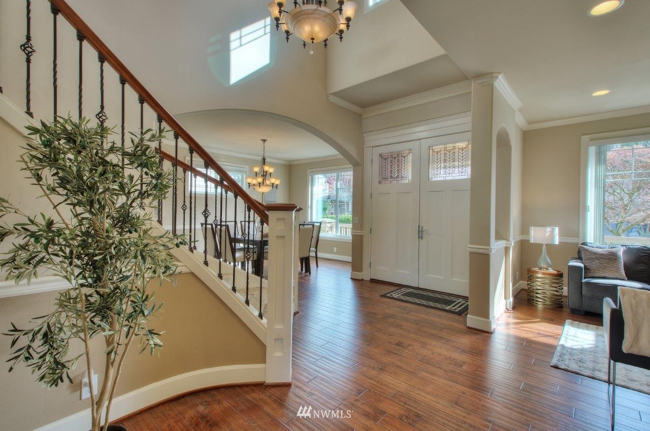 123 Ilwaco Place Southeast Renton, WA 98059 - Photo 3 of 33 a view of an entryway with wooden floor and stairs