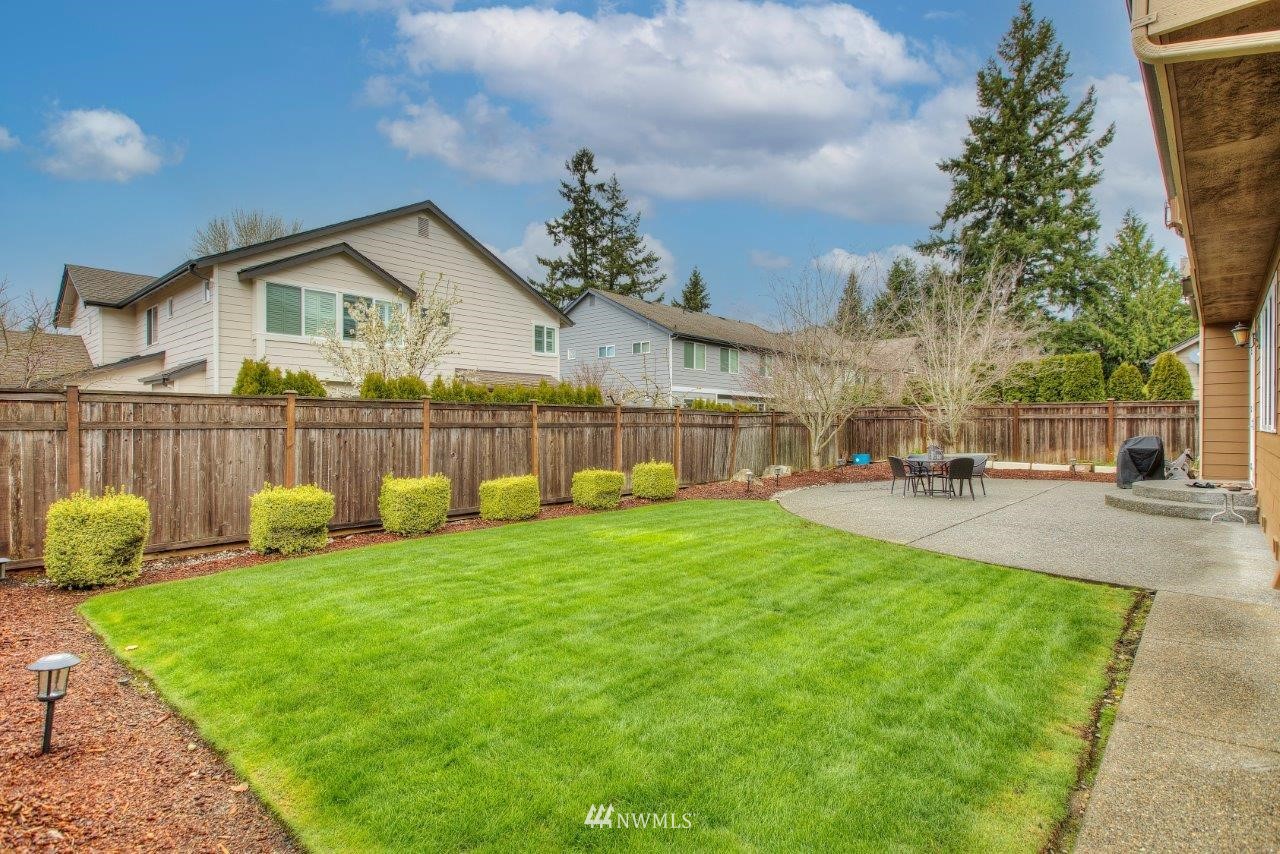 123 Ilwaco Place Southeast Renton, WA 98059 - Photo 32 of 33 a view of a house with a yard and sitting area