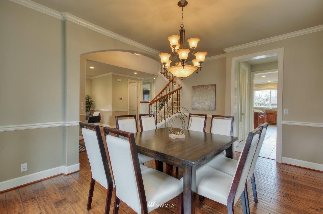 123 Ilwaco Place Southeast Renton, WA 98059 - Photo 7 of 33 a view of a dining room with furniture and wooden floor