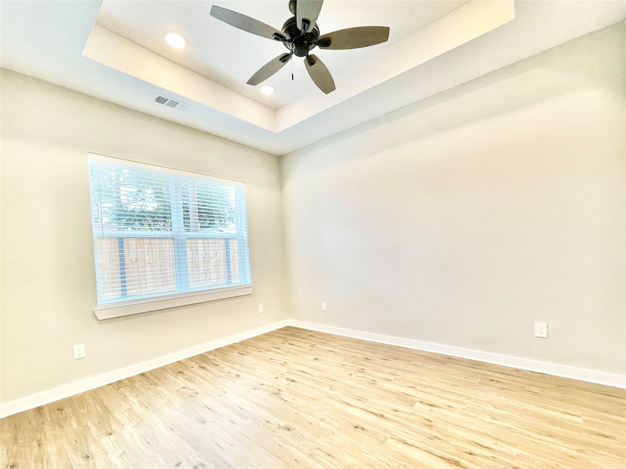 10317 Lake Road, Unit 4A Houston, TX 77070 - Photo 10 of 14 a view of an empty room with window and a ceiling fan